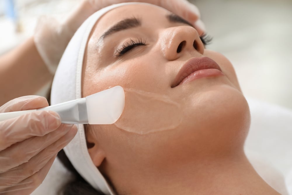 Woman receiving chemical peel treatment.